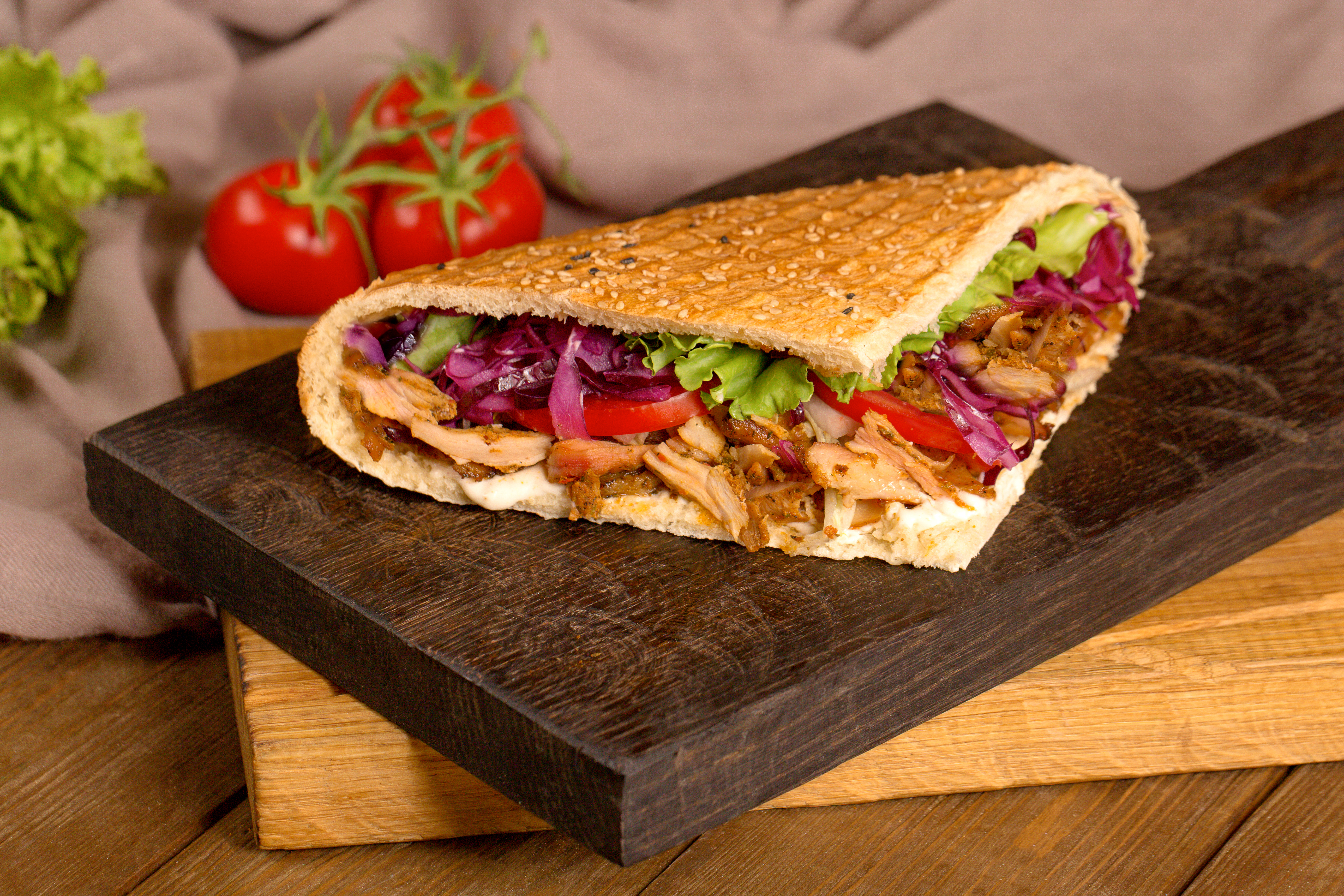 chicken doner in bread on a wooden board